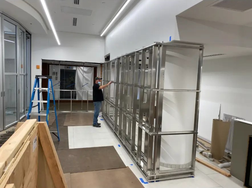Installer assembling steel framing for a branch feature wall